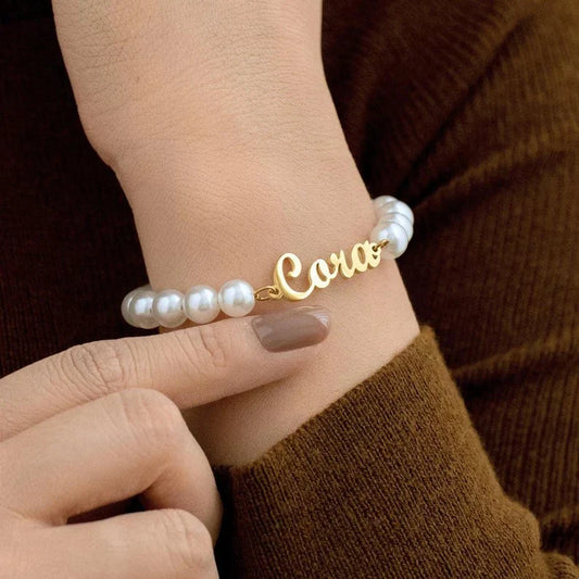 Model's hand wearing the elegant Eraya Jewel 'Your Name Pearl Bracelet'