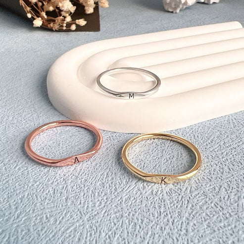 Eraya Jewel custom initial letter rings displayed in three beautiful finishes: romantic rose gold-plated, classic sterling silver, and luxurious gold-plated.