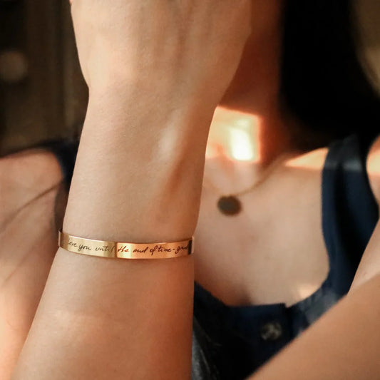 Close-up: Model's wrist featuring an Eraya Jewel Golden 'Real Handwriting' Cuff Bracelet, highlighting the unique engraved actual handwriting.
