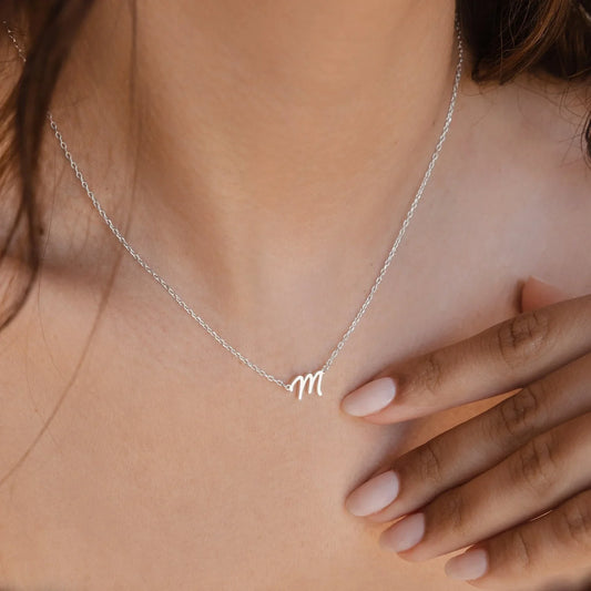 Model wearingClose-up of the Eraya Jewel Initial Letter Pendant with the letter 'M,' showcasing the refined finish and the elegant simplicity.