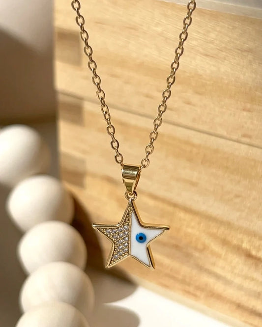 close up of star pendant with evil eye and crystal detailing