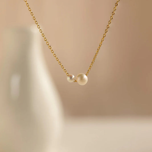 close up of dual pearl pendant with 5mm and 8mm freshwater pearls on fine gold chain