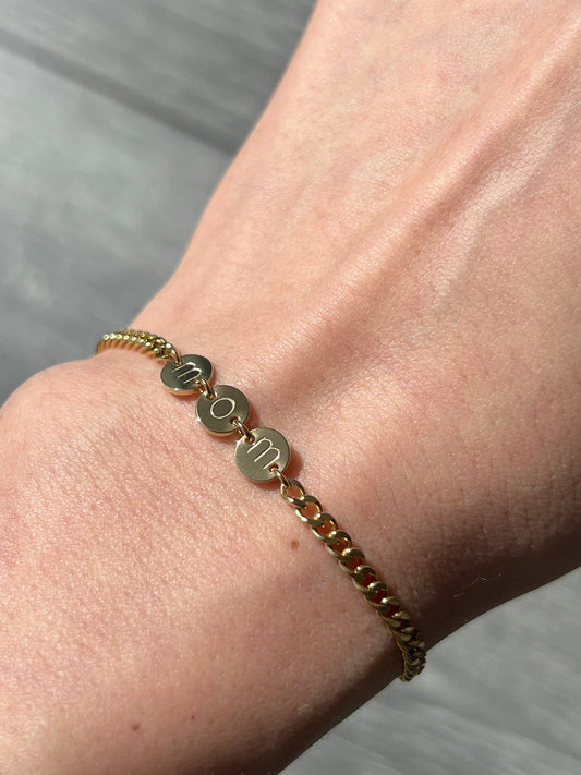 Girl wearing gold forever mine bracelet engraved mom