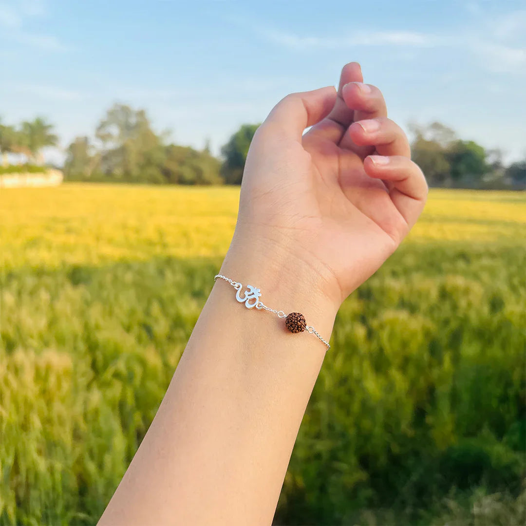 Close-up of 925 silver chain bracelet with Om symbol and Rudraksha bead – handmade Hindu religious accessory
