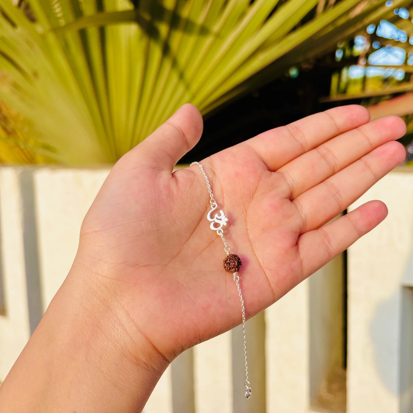 Elegant Om Rudraksha bracelet on wrist – perfect spiritual gift with natural healing energy
