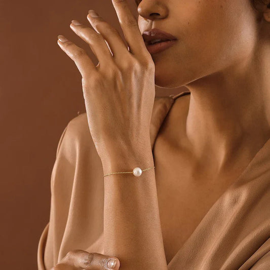Model wearing the delicate Eraya Jewel Single Pearl Bracelet in Gold Polish