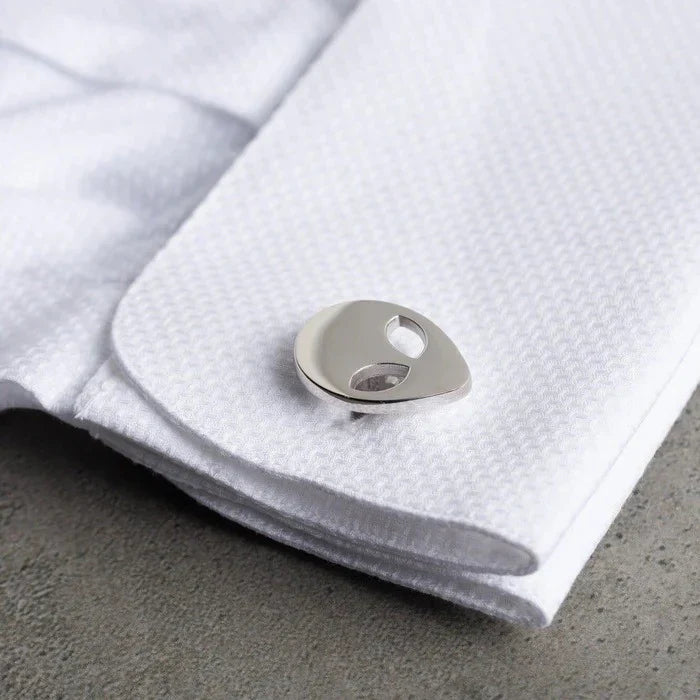 Man's shirt cuff featuring Eraya Jewel Alien Cufflinks in Silver, adding a playful sci-fi touch to his attire.