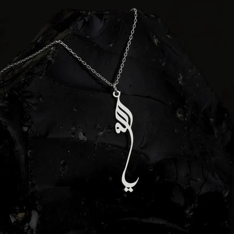 Noor Allah Necklace displayed on a black stone, highlighting the elegant and refined Islamic motif.