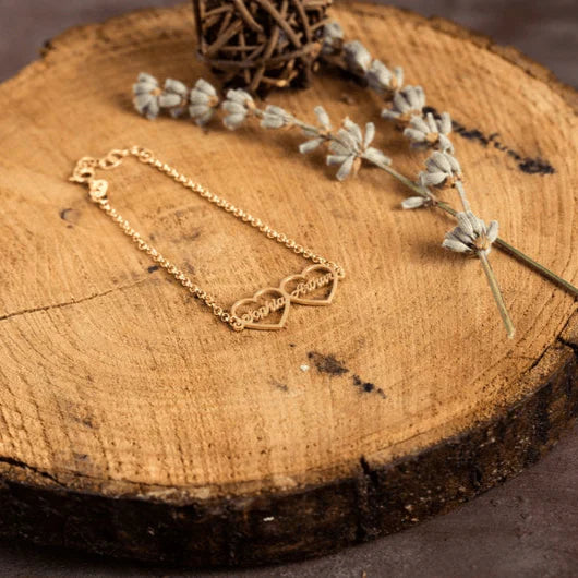 Product image of the Eraya Jewel Custom 'His and Hers' Heart Name Bracelet set in a luxurious Gold finish, perfect as a personalized couple's gift.
