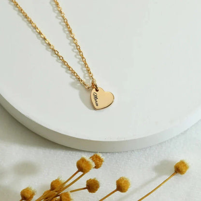 olo shot of the Eraya Jewel Custom Heart with Family Name pendant, emphasizing the heart shape, the engraving detail