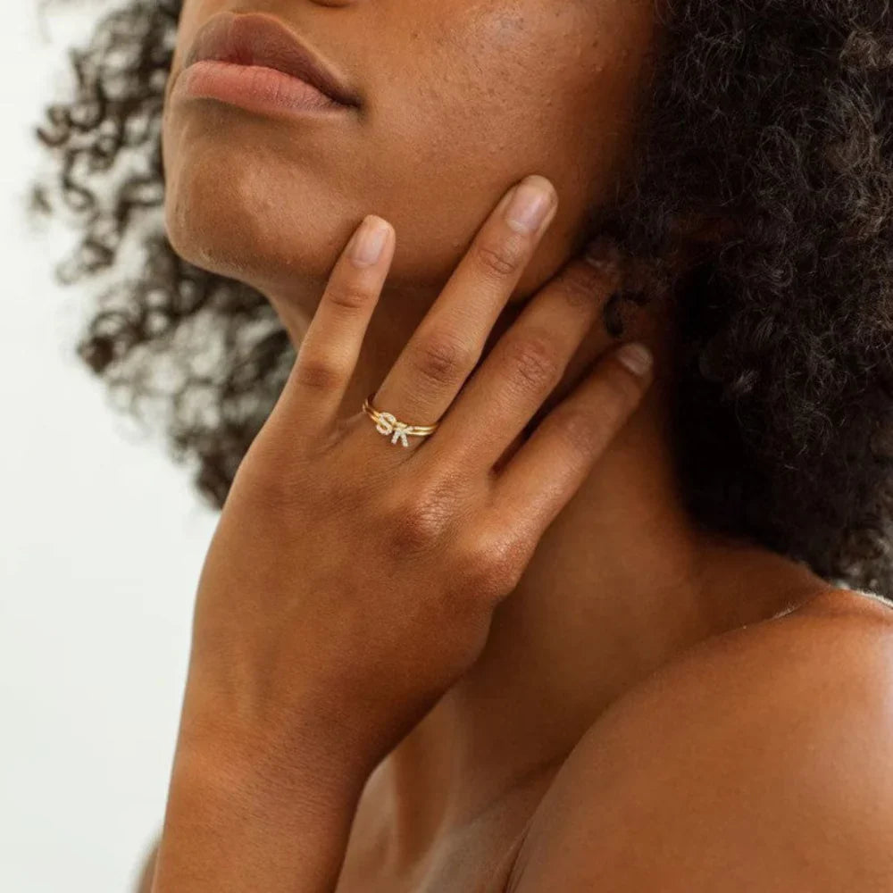 Model's hand showcasing the sparkle of a Custom Pavé Diamond Initial Ring.