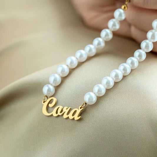 Product shot of the Eraya Jewel 'Your Name Pearl Bracelet' gold Finish on a white background, showcasing custom engraving