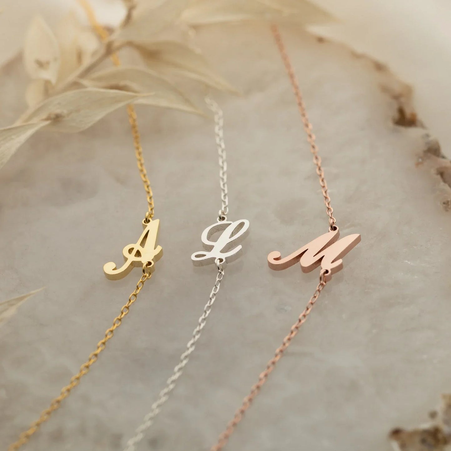 Eraya Jewel 'Carrie Font' Initial Bracelets available in Gold, Silver, and Rose Gold finishes, showing personalized letter options.