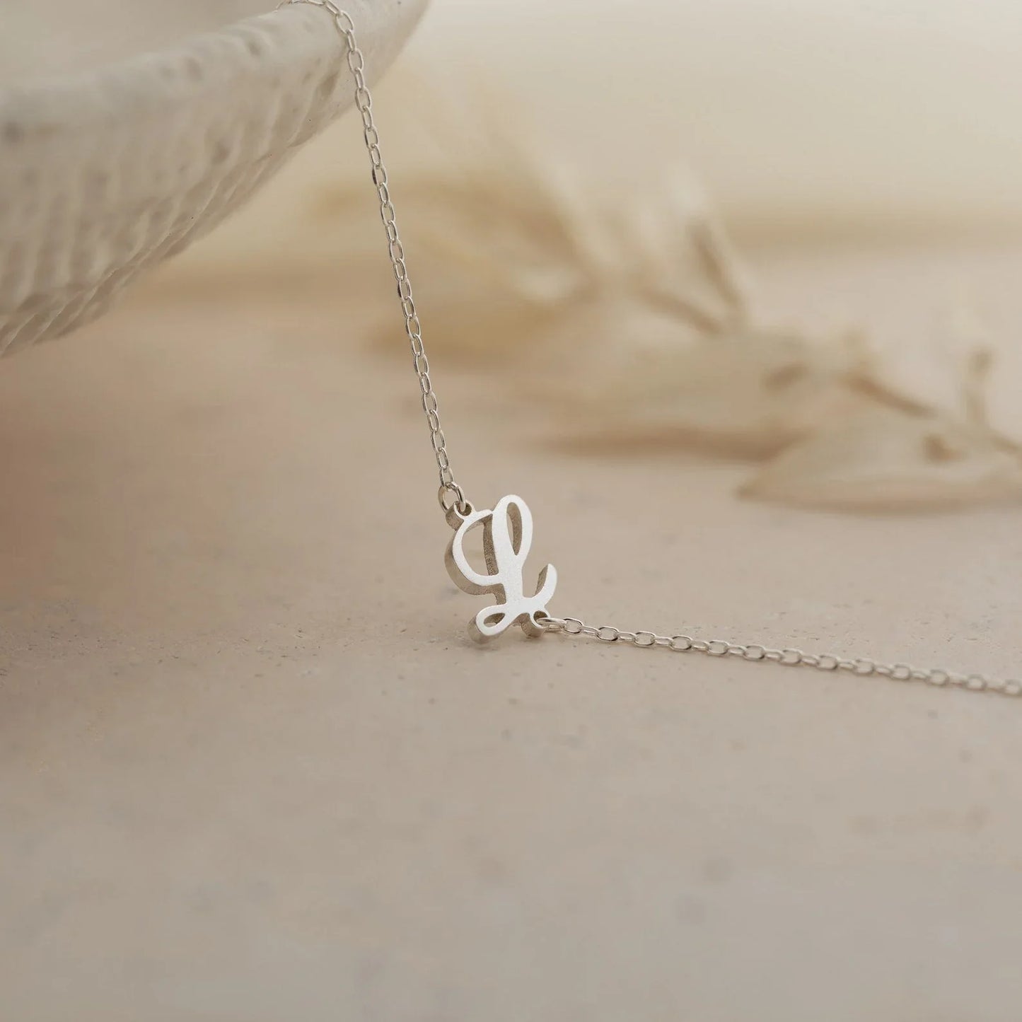 Product image of the Eraya Jewel 'Carrie Font' Initial Bracelet in polished Silver, detailing the distinctive 'Carrie' script style initial.