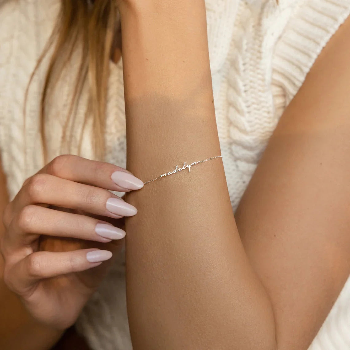 Woman showcasing her Eraya Jewel Dainty Name Bracelet in Silver, a perfect subtle personalized accessory for everyday wear