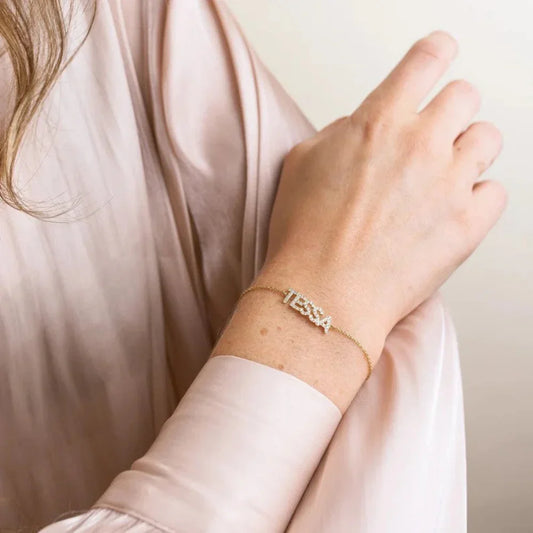 Model elegantly wearing an Eraya Jewel Custom Diamond Name Bracelet, with a personalized name sparkling with brilliant diamonds on her wrist.