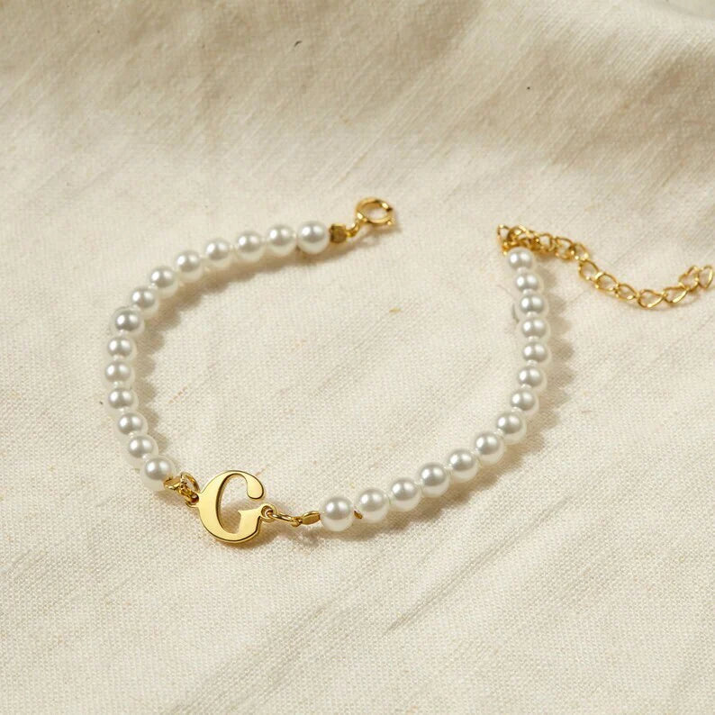 Your Initial Letter Pearl Bracelet' with Gold Polish finish displayed on a white background.