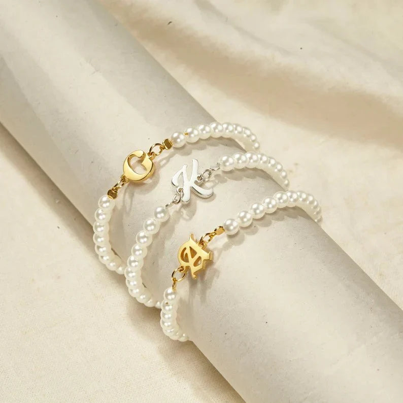 Detailed view of the customizable  initial charm and pearl strand of the Eraya Jewel bracelet Gold/Silver Polish