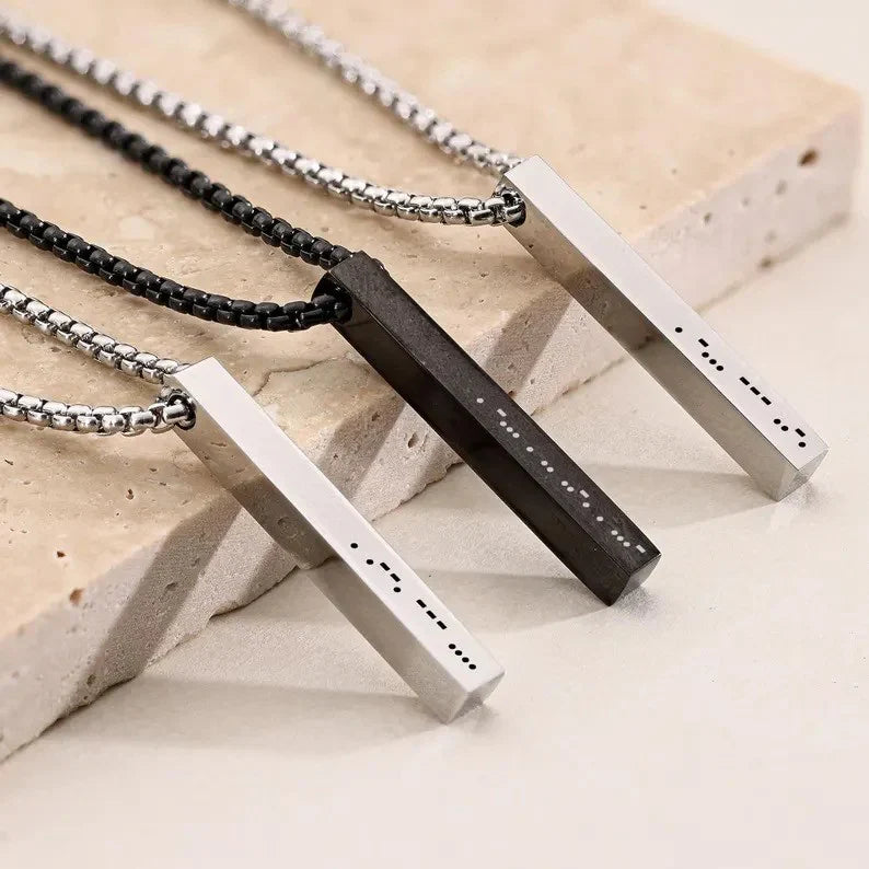 Display of the Custom Men's Morse Code Bar Pendant collection in gold, silver, and black finishes, emphasizing versatile modern style.