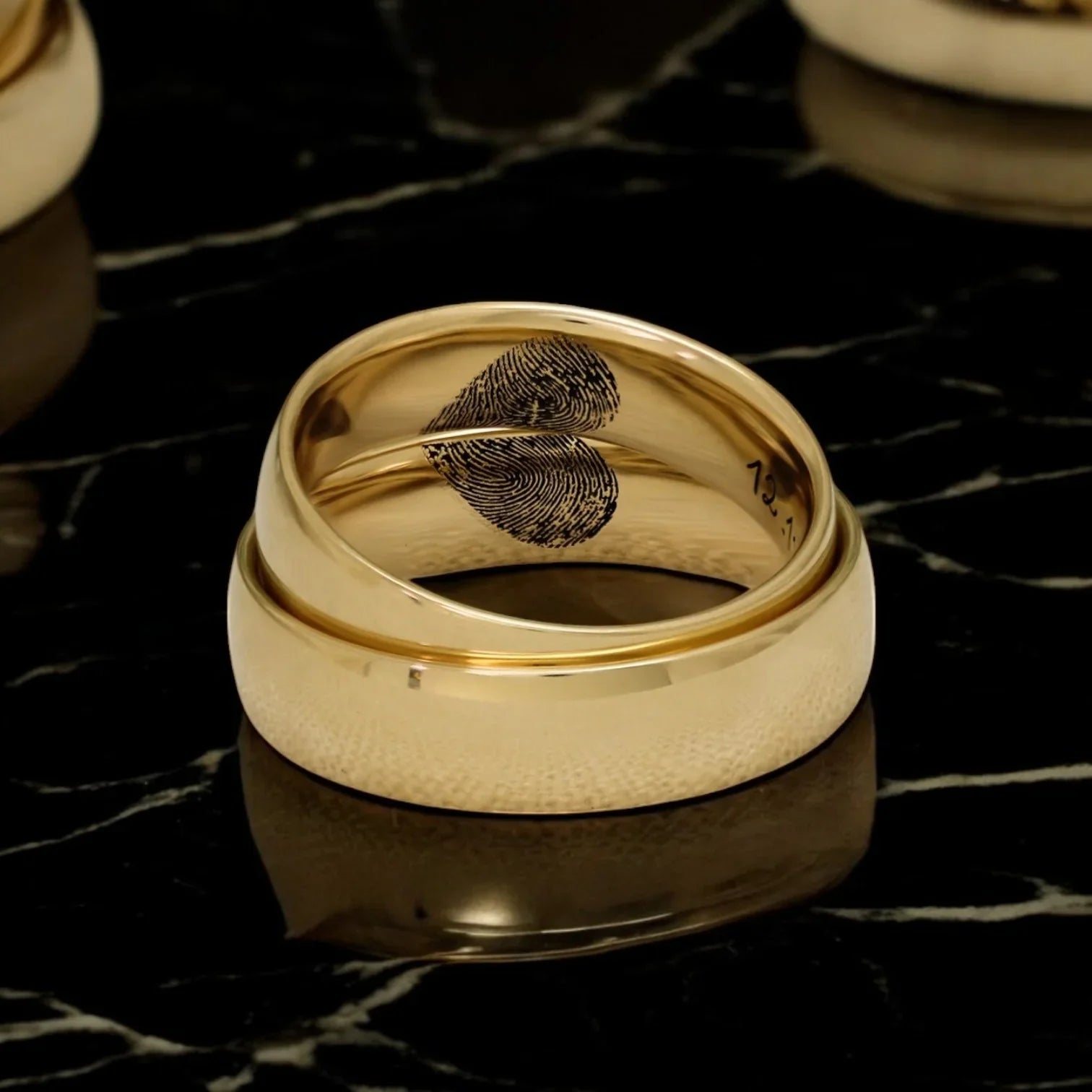 A gold ring from Eraya Jewel with the name "Theodore" engraved on the outside.