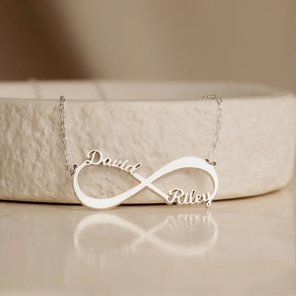Close-up of the Personalized Name Infinity Necklace in gold, showcasing custom engraved names on a sleek infinity symbol
