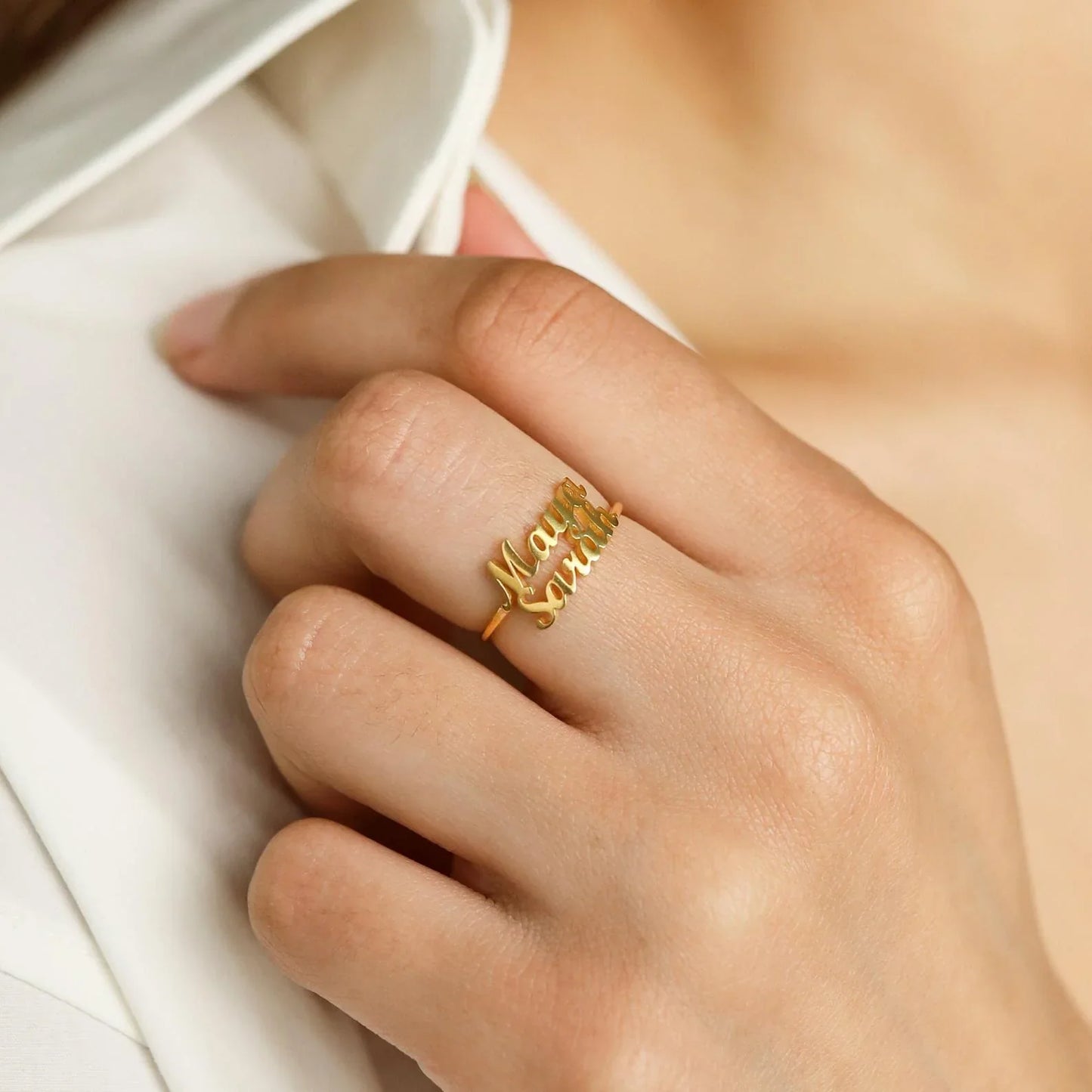 A detailed close-up showcasing the engraved names on two matching London-style rings, highlighting the craftsmanship and elegant design.
