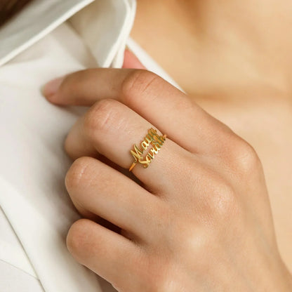 A detailed close-up showcasing the engraved names on two matching London-style rings, highlighting the craftsmanship and elegant design.