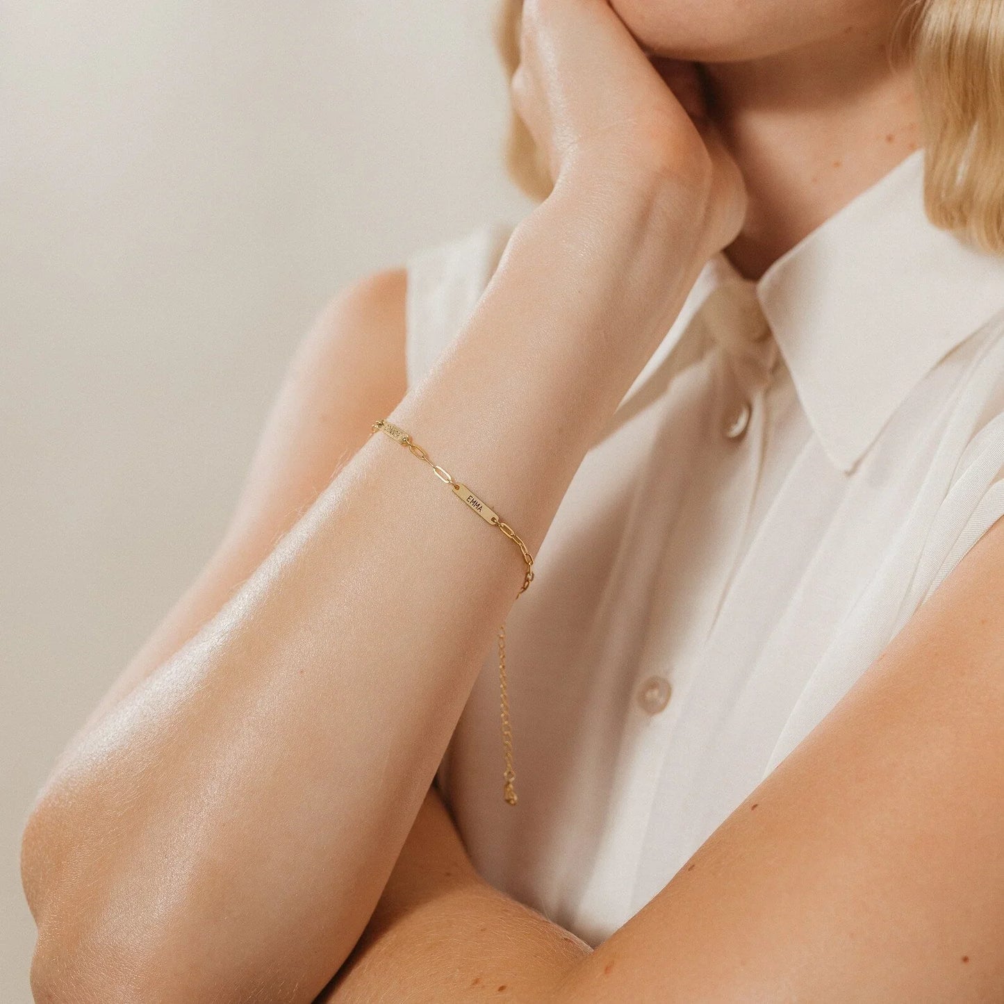 Model displaying the chic Eraya Jewel Engraved Mini Name Bar Bracelet in a Gold finish, a perfect personalized everyday accessory