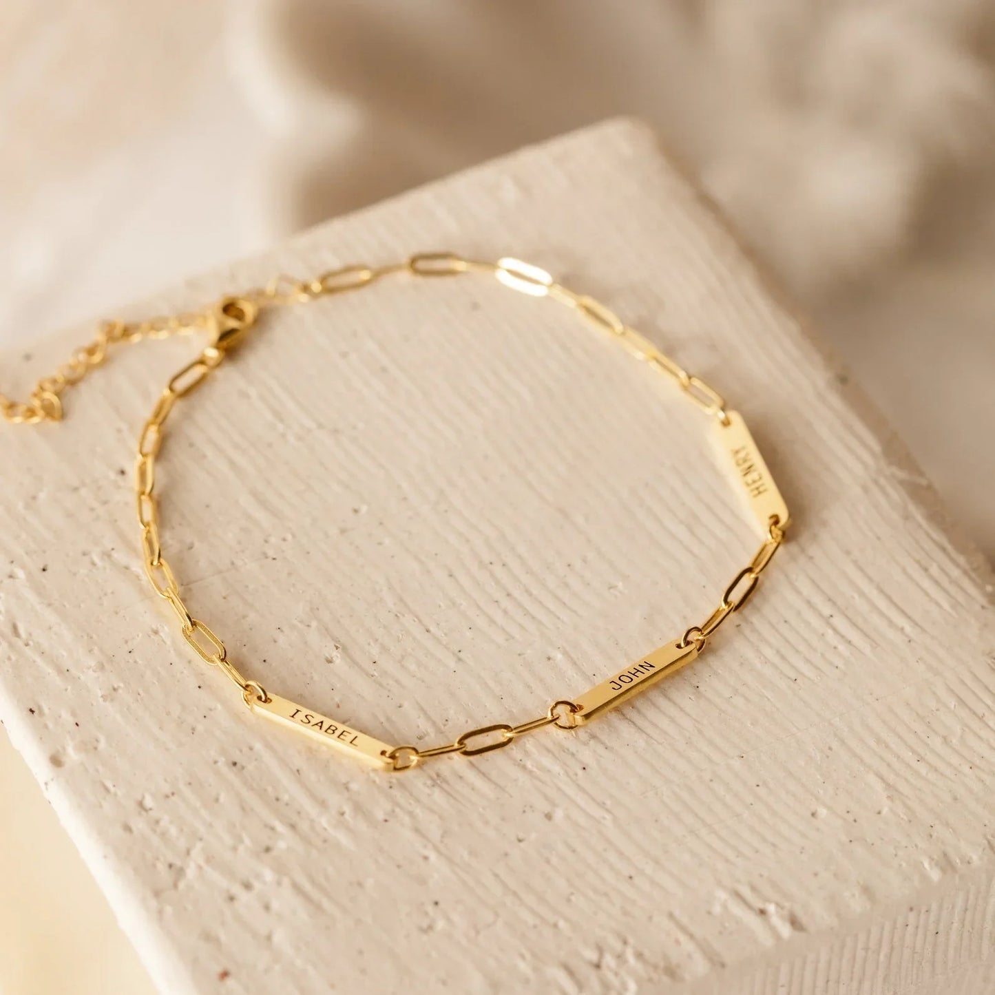 Product image of the Eraya Jewel Engraved Mini Name Bar Bracelet in polished Gold, detailing the fine chain and customizable mini name bar.
