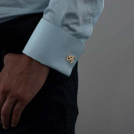 Man wearing Eraya Jewel 'My Initials' Cufflinks in Gold, showcasing a sophisticated personalized accessory on a shirt cuff.

