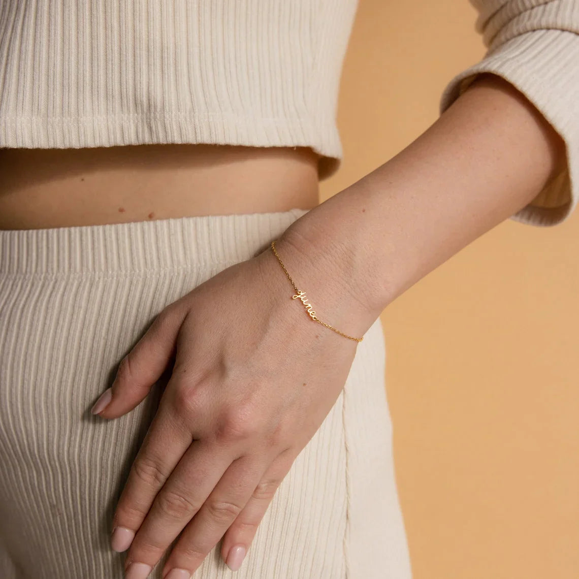 Delicate custom name detail on an Eraya Jewel Dainty Layering Name Bracelet, as worn by a model, showcasing its personal touch.