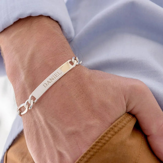 Man's wrist adorned with an Eraya Jewel Custom Engraved Men's ID Bracelet in Silver, highlighting its sleek design and custom engraving.