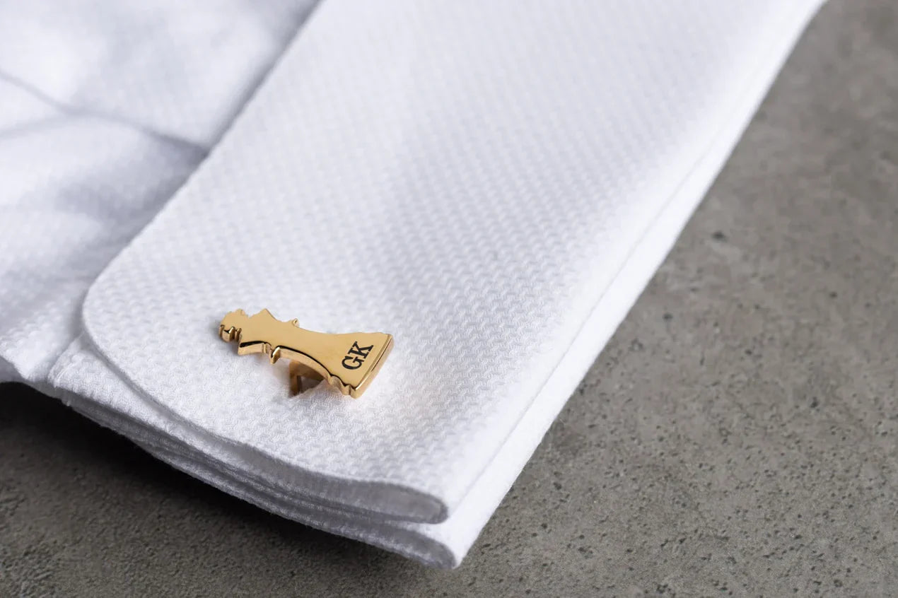 Man's shirt cuff adorned with Eraya Jewel Golden Custom Two-Letter Chess Cufflinks, featuring personalized initials in a stylish chess-themed design."