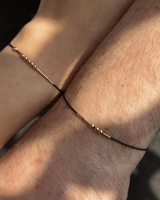 Delicate Morse code bracelet on wrist with lightweight cord and metal accents