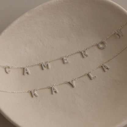 Detailed view of a custom Pavé Letter Name Necklace showing brilliant CZ stone setting and luxury personalized craftsmanship.