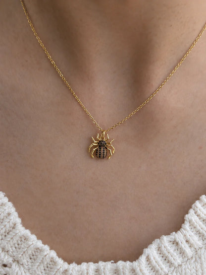 High-quality shot of a spider pendant with black and clear zircon diamonds in an 18k gold finish.