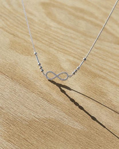 Family Initial Morse Code Necklace by Eraya showcasing personalized initials linked by an infinity bond symbol.
