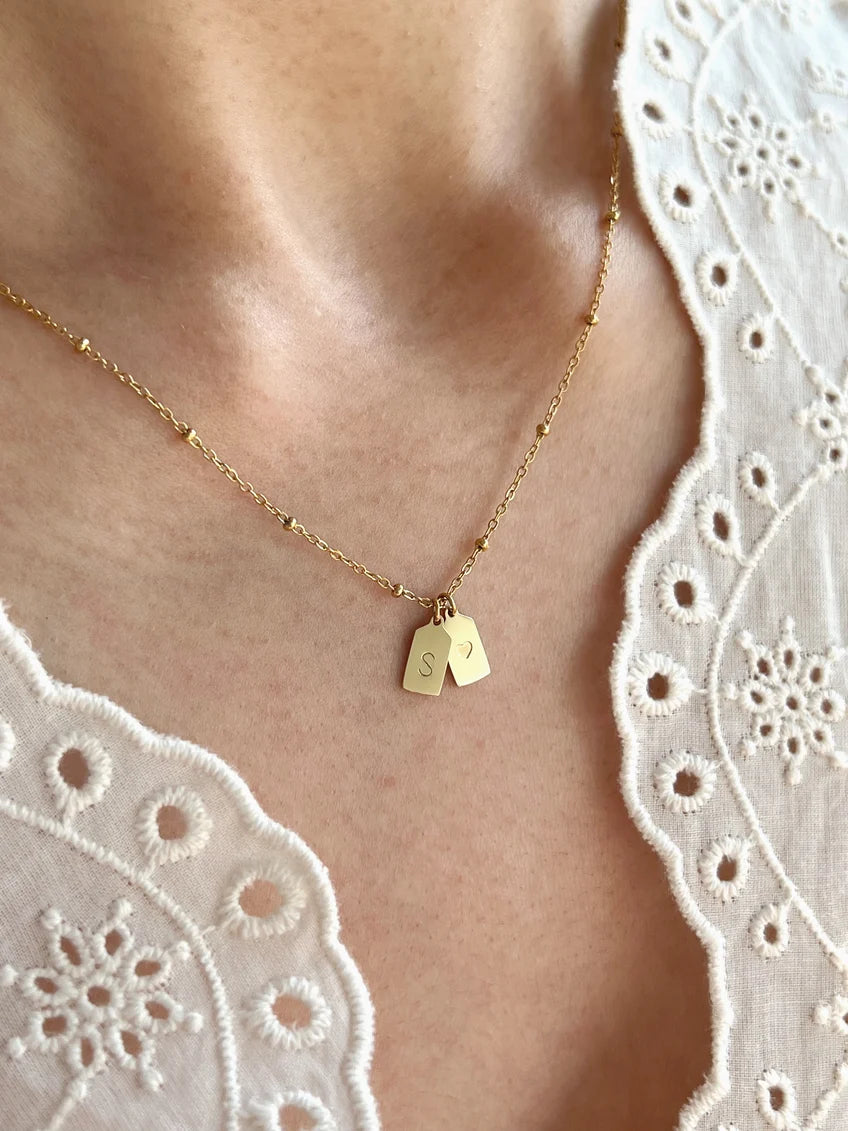 Eraya Jewel personalized couple heart initial necklace worn on the neck with delicate engraved tag charms