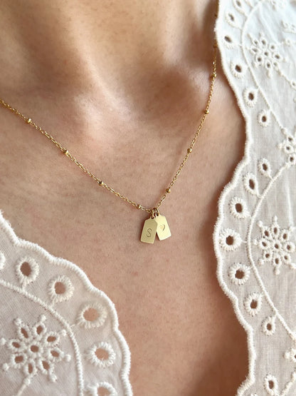 Eraya Jewel personalized couple heart initial necklace worn on the neck with delicate engraved tag charms