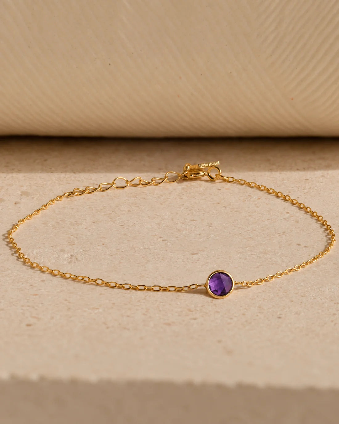 Eraya Jewel dainty birthstone bracelet featuring a purple February birthstone in 22K gold finish