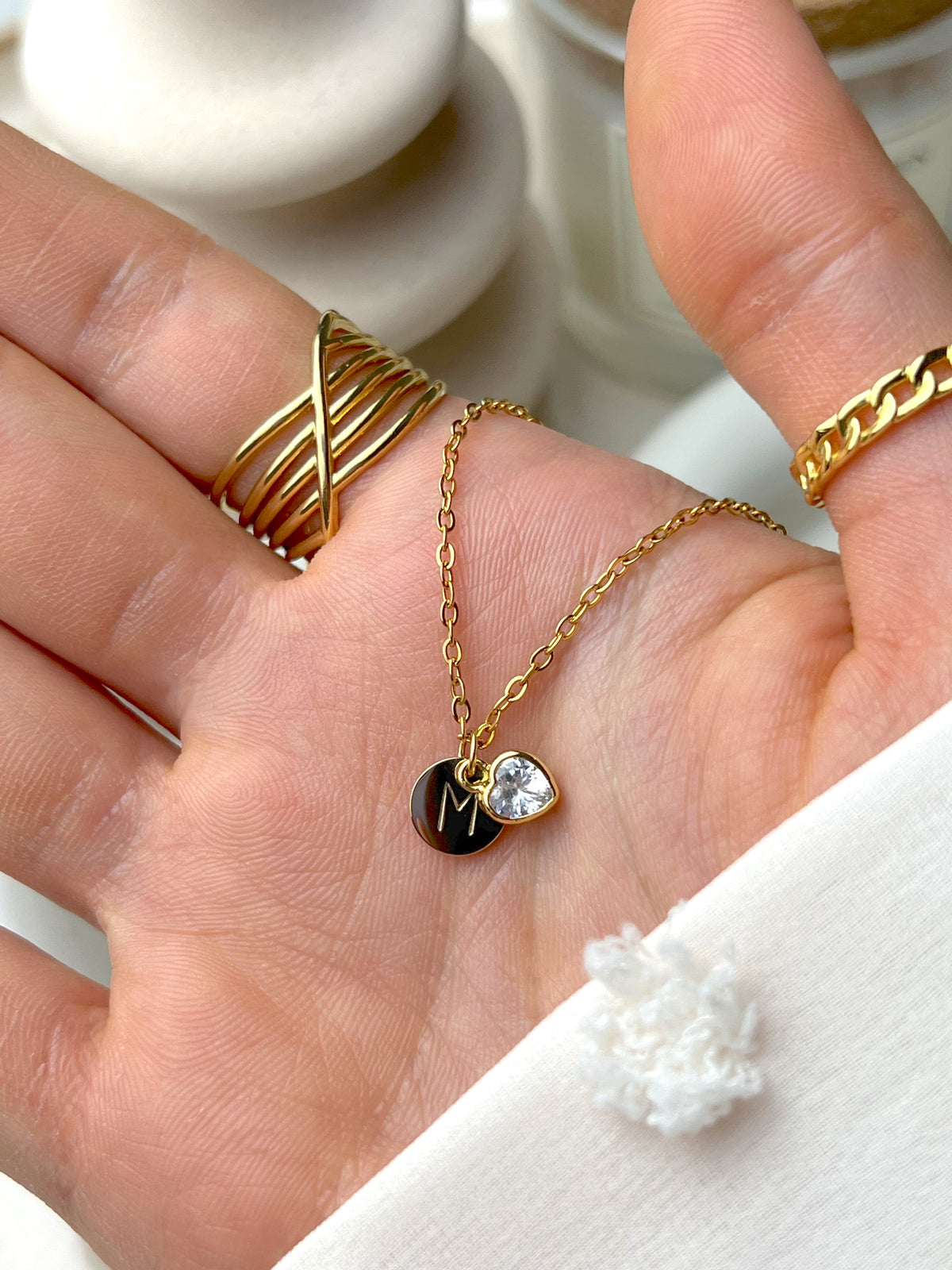 Eraya Jewel hidden initial heart necklace worn with a personalized initial behind the heart charm
