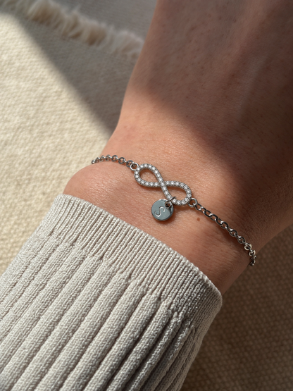 Eraya Jewel silver personalized pavé infinity bracelet with initial coin and zircon stones