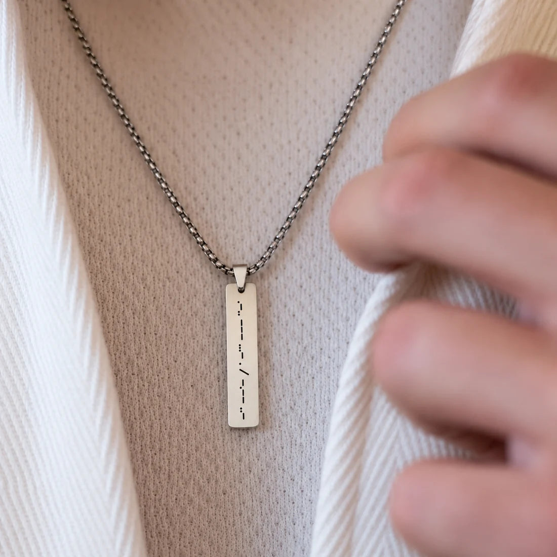 Eraya Jewel personalized silver Morse Code Bar Pendant with hidden message worn on a man