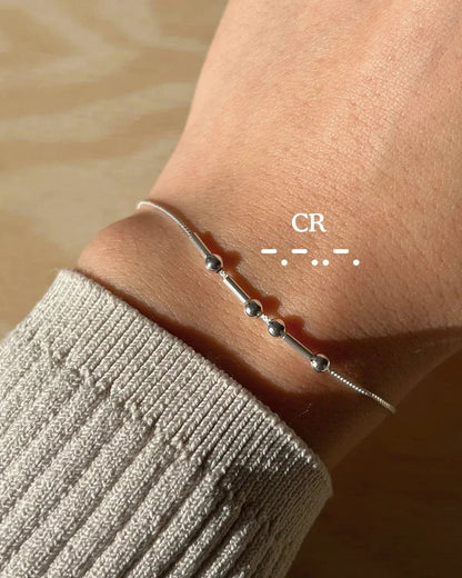 Eraya Jewel silver personalized Morse code bracelet worn on a wrist with CR encoded in dots and dashes