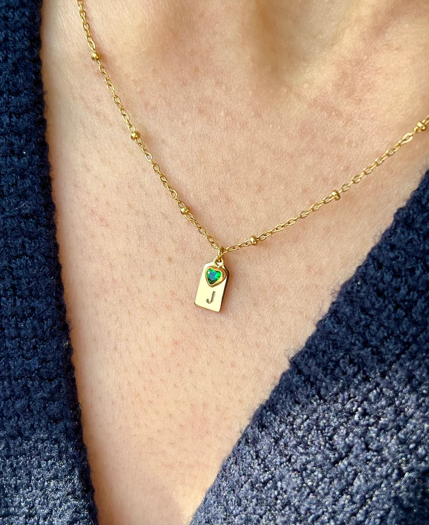 Minimal personalized birthstone necklace with engraved initial tag and blue charm