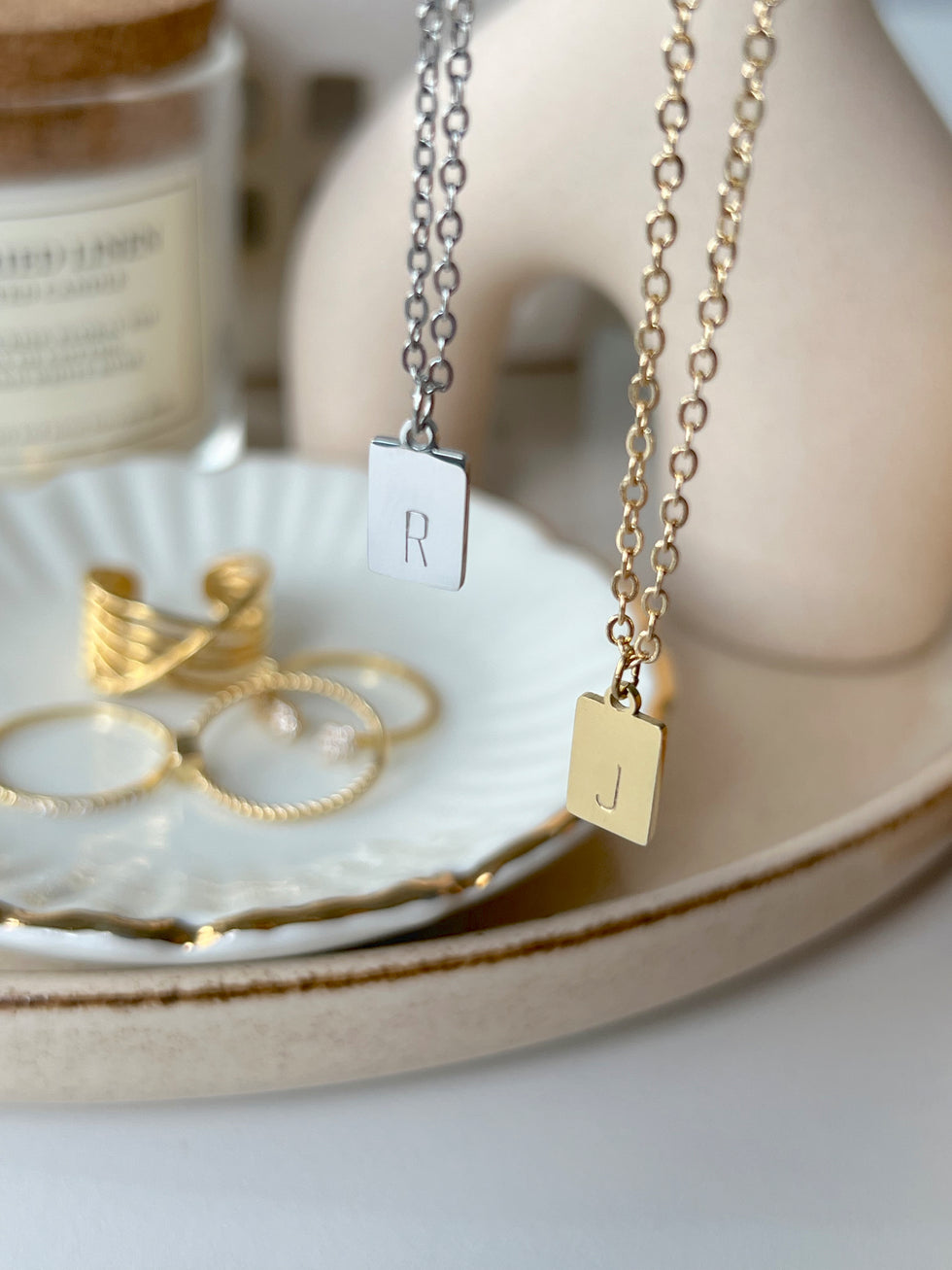 Silver and gold tiny rectangle initial pendants hanging side-by-side – personalized letter necklaces for women