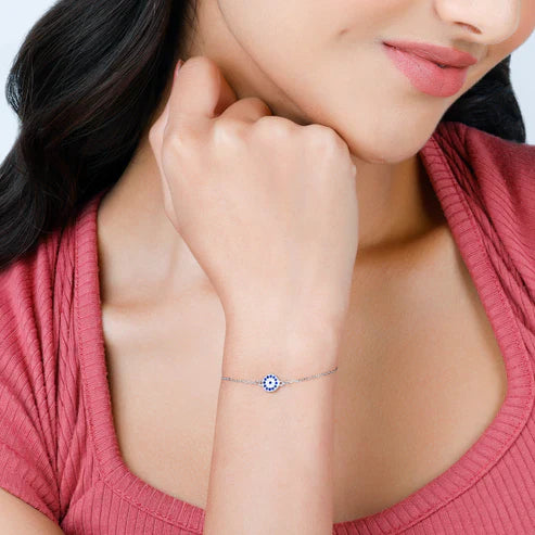 Model's wrist adorned with the Eraya Jewel 925 sterling silver evil eye bracelet, showcasing the protective blue evil eye charm on a delicate silver chain.