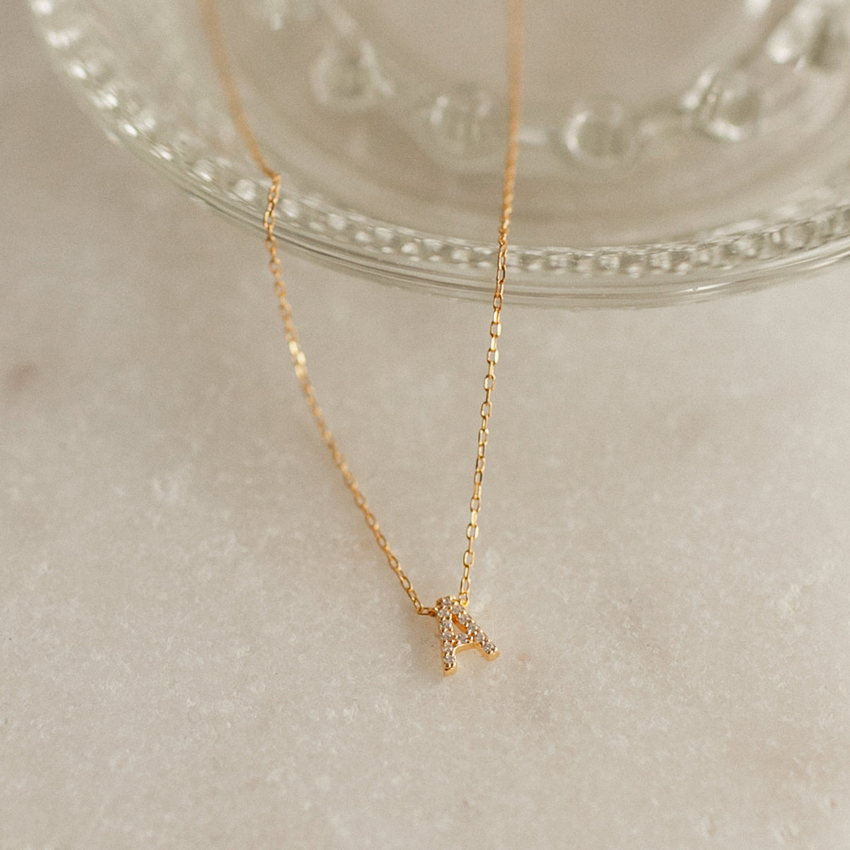 Personalized Gold Initial Necklace with a 7mm pavé CZ letter A pendant for everyday wear.