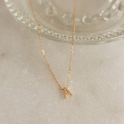 Personalized Gold Initial Necklace with a 7mm pavé CZ letter A pendant for everyday wear.