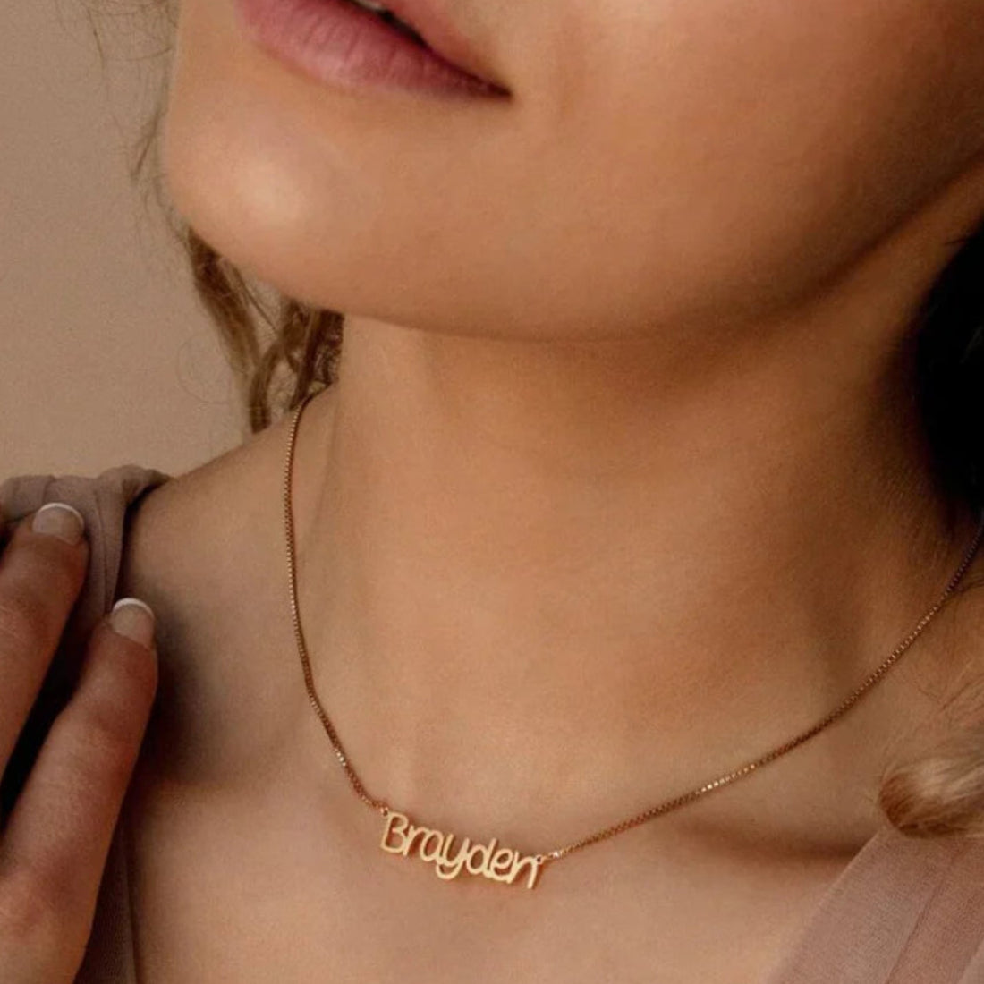 Close-up of a model wearing the Personalized Callie Signature Necklace in silver, highlighting the elegant engraved signature.